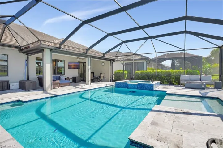 View of pool featuring a lanai, an in ground hot tub, an outdoor hangout area, and a patio