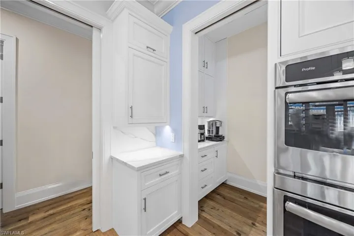 Butlers pantry off of kitchen with coffee bar and additional storage.