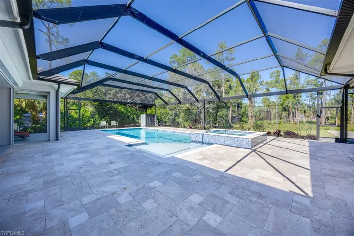 Huge saltwater pool and hot tub, full pavers and large panel view high cage.