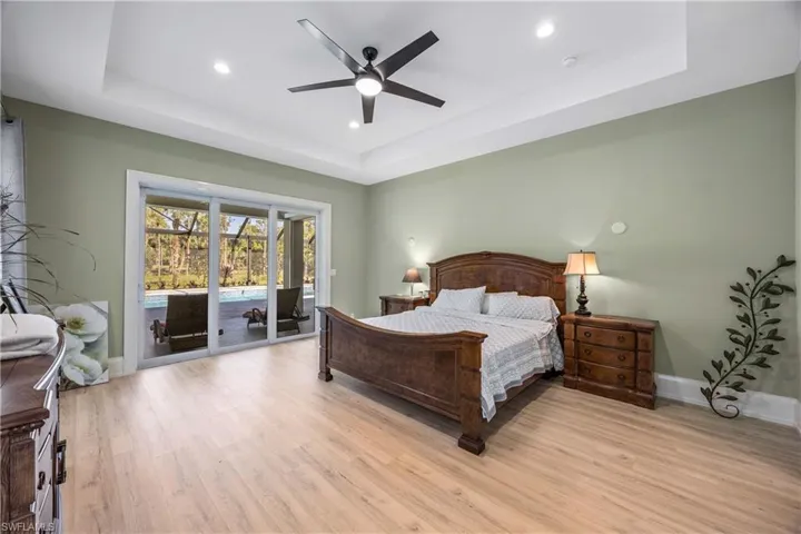King Bed and slider to lanai/pool.
