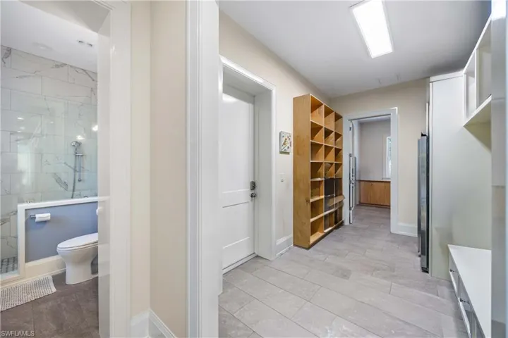 Large mudroom off of garage entry, with extra refrigerator and storage.