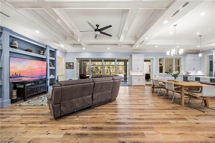 Living area with large sectional sofa and big screen TV.