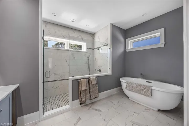 Luxurious soaking Tub and huge walk-in Shower, tiled floor.