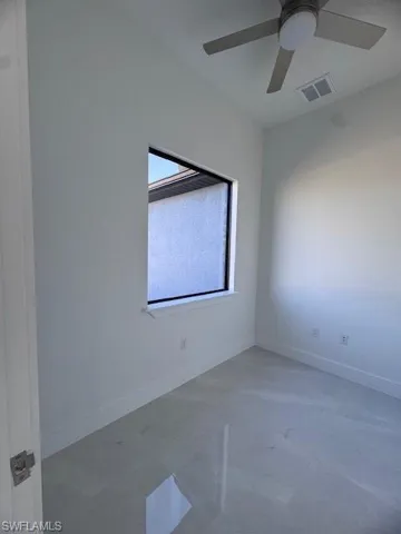 Spare room with ceiling fan
