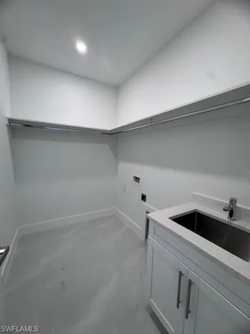 Laundry area with washer hookup, sink, and electric dryer hookup