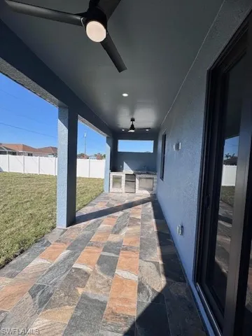View of patio / terrace featuring an outdoor kitchen and ceiling fan