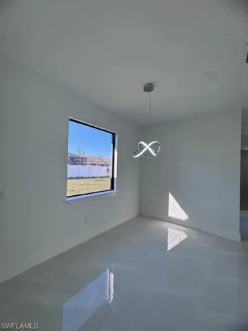 Unfurnished dining area featuring a notable chandelier