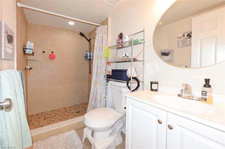 Bathroom with vanity, a shower stall, and recessed lighting