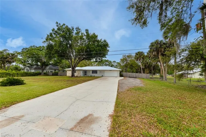 Ranch-style home featuring driveway and an attached garage