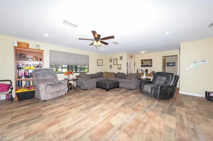Living area featuring ceiling fan and light wood-style floors