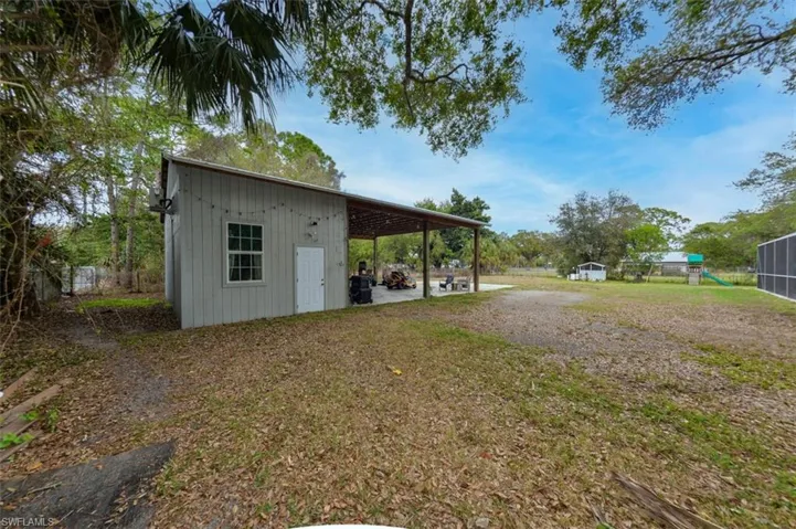 View of yard with a patio area and an outdoor structure