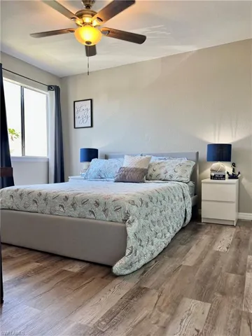 Bedroom with wood finished floors and ceiling fan