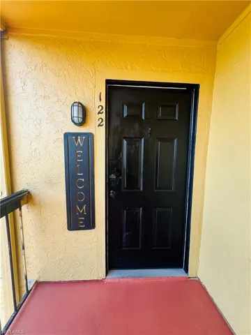 Entrance to property with stucco siding