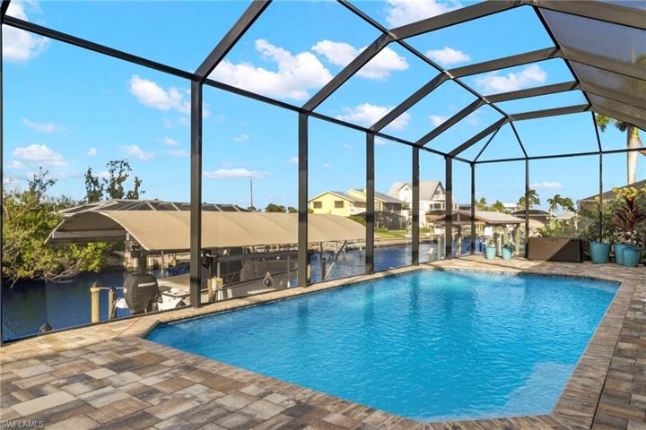 Just a hop, skip and jump to the open waters!  Pavered lanai, canopied boatlift and a sunny and islandy lifestyle!