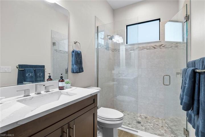 Guest bathroom # 1 - more designer tile and upgraded glass, those beautiful counters and upgraded faucets!