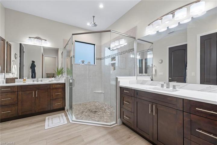 His and hers vanities with large walk in resort style shower -rainhead, shaveng bench and the most beautiful tile details!  Cambria quartz counters complete this designer look!