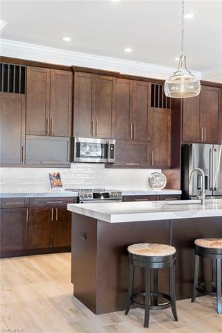 Custom kitchen cabinets, 42 inch with crown molding, upgraded handles, sink and counter tops.