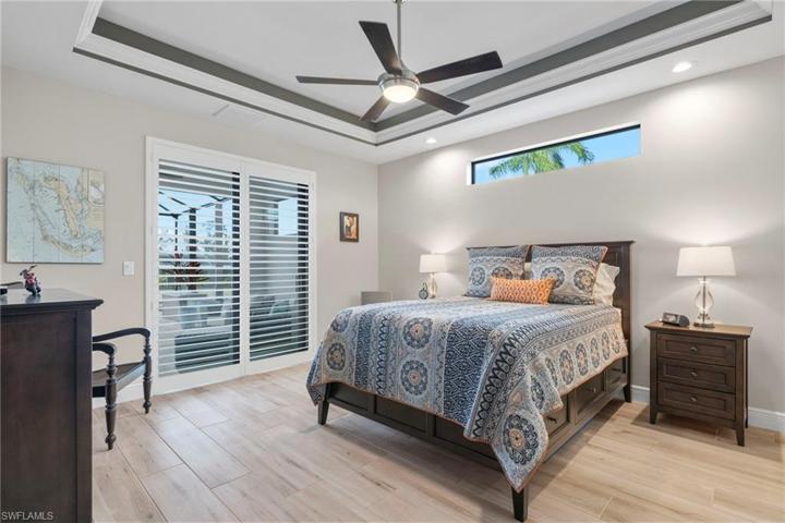 Lots of natural light through the transom window and plenty of space for large bedroom furniture.  Sliders lead out to the outdoor area and the pool and water!