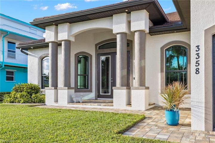 Curb appeal!  Grand columns welcome you to a double door entry with all hurricane impact windows and doors throughout the home.  Step through the doors into a welcoming foyer with views straight to the outside and the beautiful pool area.