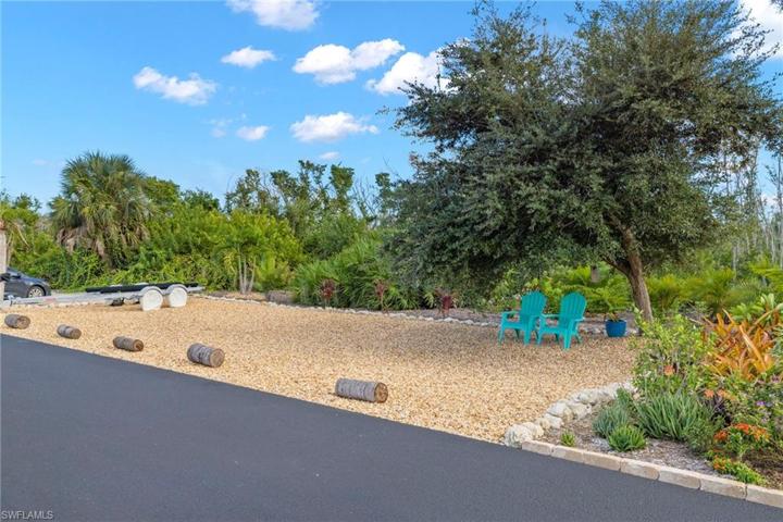 Another view of the manicured additional land that goes with this property - perfect for overflow parking, outdoor gatherings and another magical part of the Manatee Bay POA.