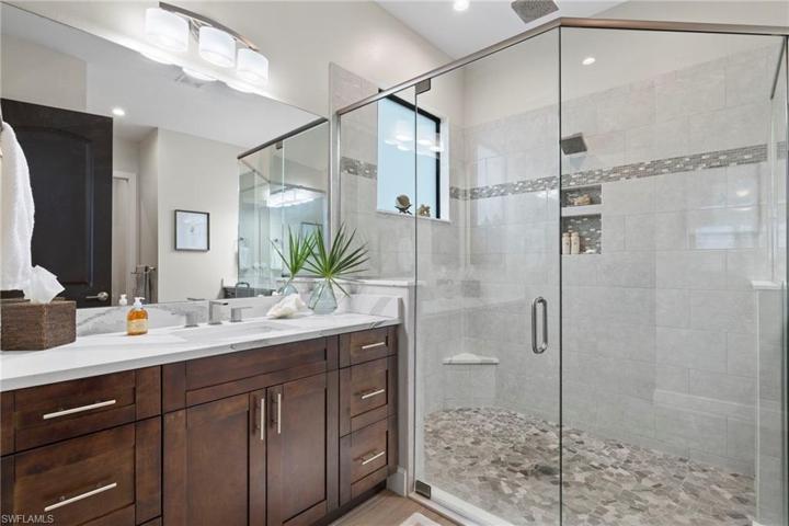 Upgraded everything, even the cabinet hardware (throughout the entire home).  More natural light, glass enclosure and a large shower.