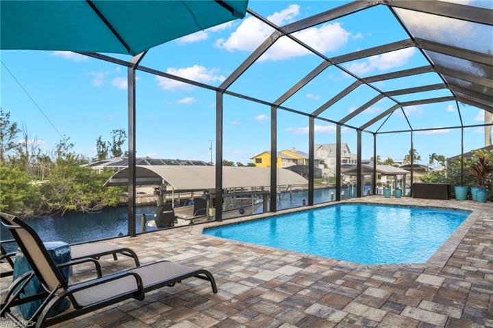 Sparkling and  heated pool with extended seating ledge with therapy jets, noseeum screens and plenty of place for outdoor furniture.