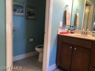 Bathroom with dual sink vanity and toilet
