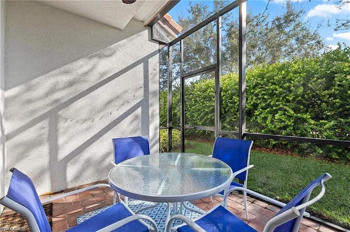 Sunroom featuring outdoor dining area, freshly painted and private backyard