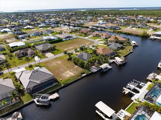 Birds eye view of property with a water view