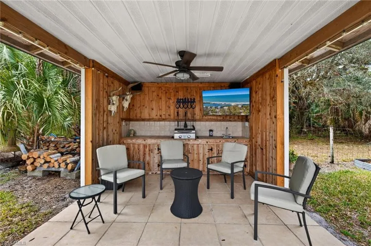 View of patio featuring ceiling fan and a sink