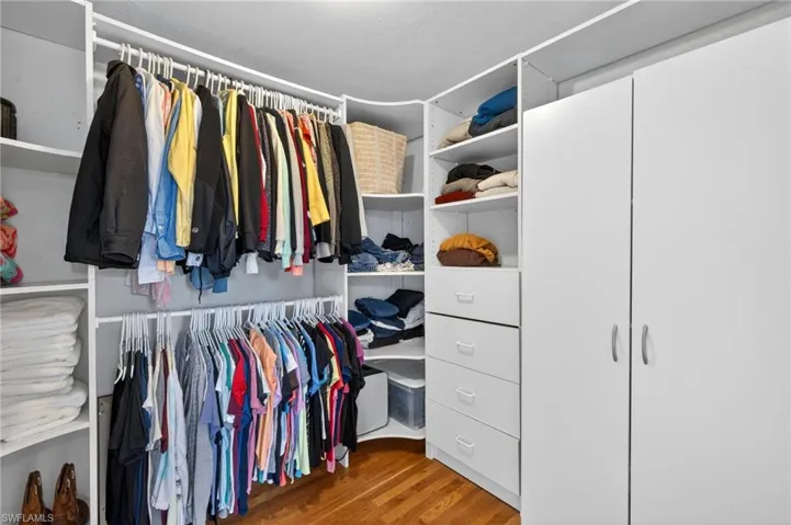 Walk in closet featuring dark wood-style flooring