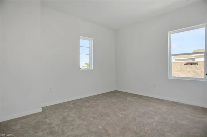 Unfurnished room with carpet flooring and baseboards