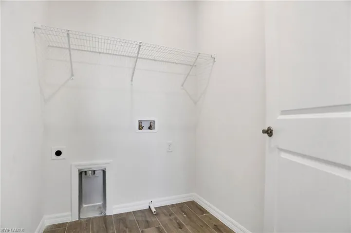 Laundry area with wood tiled floors, hookup for a washing machine, and hookup for an electric dryer