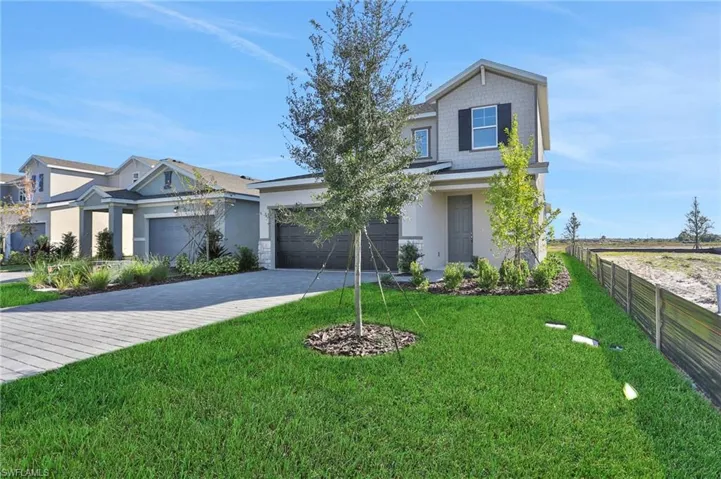 View of front of property with driveway, a garage, and stucco siding