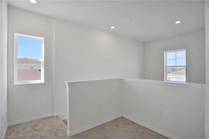Unfurnished room featuring light carpet and recessed lighting