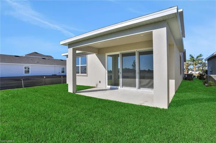 Back of property with a patio area and stucco siding