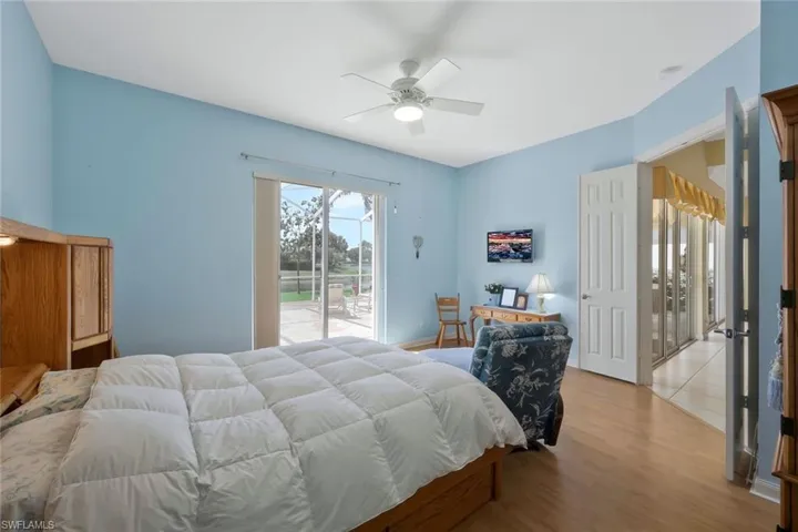 Bedroom featuring light wood-style flooring, access to exterior, and a ceiling fan
