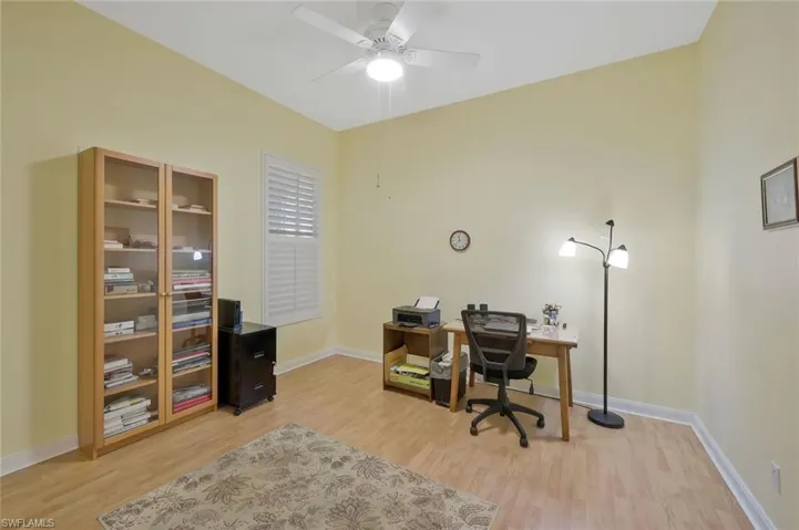 Office space with light wood-type flooring, baseboards, and ceiling fan