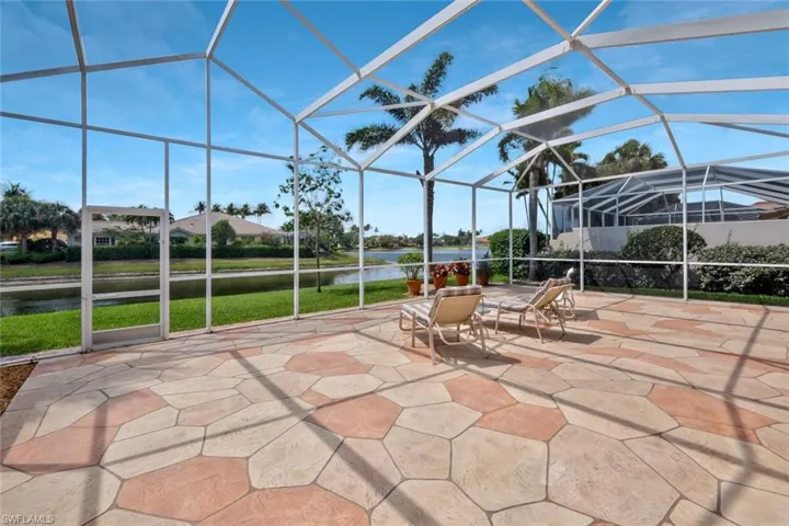 View of patio / terrace featuring a water view and a lanai