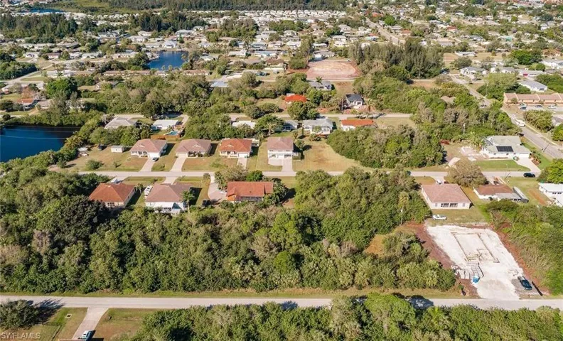Aerial perspective of suburban area with a nearby body of water