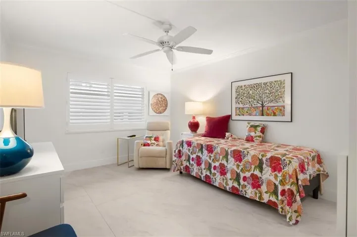 Bedroom featuring ornamental molding and a ceiling fan