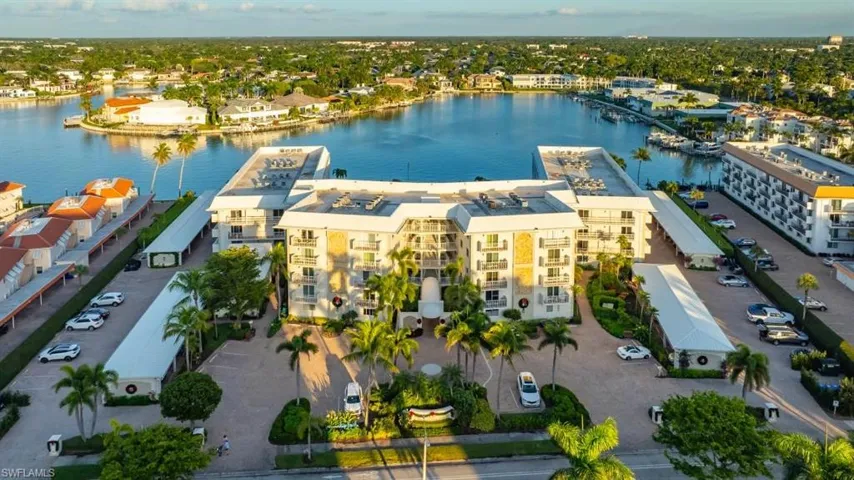 Aerial view of a nearby body of water and apartment complex / building