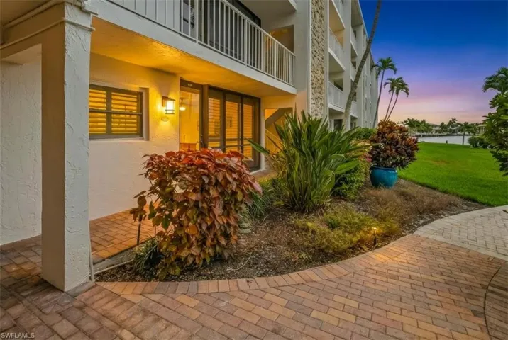 Corner unit with lush landscaping and water views