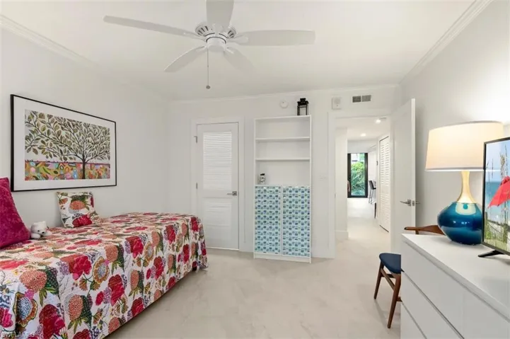 Bedroom with crown molding and ceiling fan