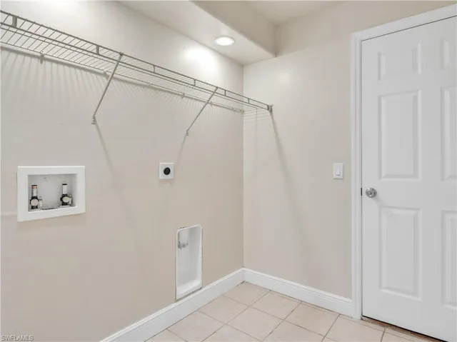 Laundry room featuring washer hookup, light tile patterned floors, and electric dryer hookup
