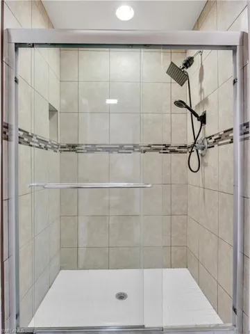 Bathroom with a shower with shower door