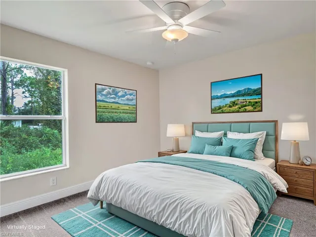 Bedroom with ceiling fan and carpet floors