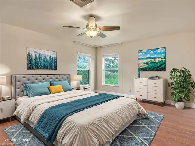 Bedroom featuring ceiling fan and hardwood / wood-style floors