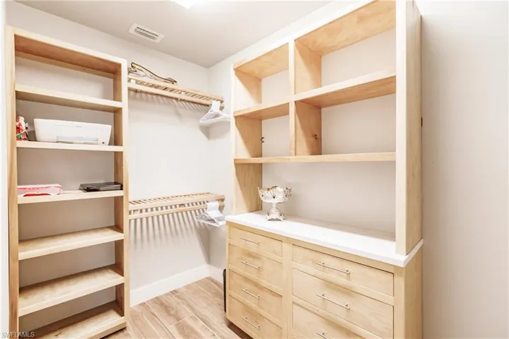Spacious closet with light wood-style floors