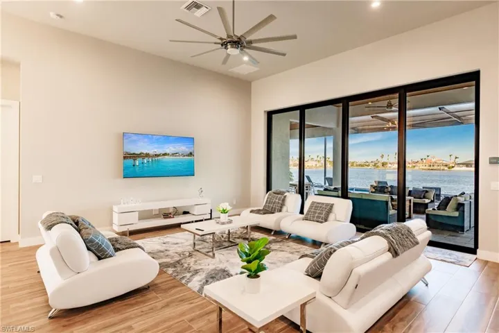 Living room featuring ceiling fan, wood finished floors, and recessed lighting